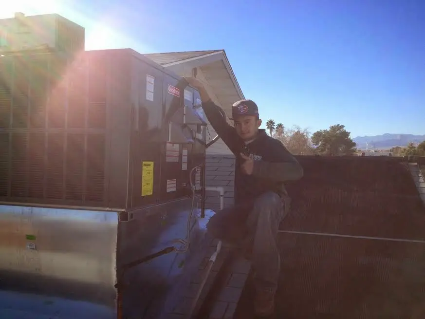 HVAC technician performing HVAC Inspection on a rooftop unit in Cold Springs